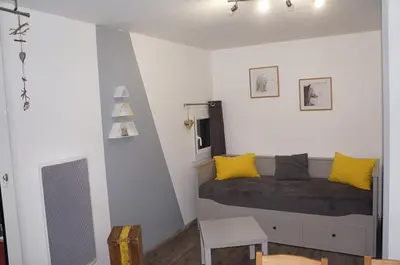 a bedroom with a bed with yellow pillows at Verseau Flaine Forêt in Arâches-la-Frasse