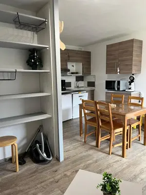 a kitchen and dining room with a table and chairs at Verseau Flaine Forêt in Arâches-la-Frasse