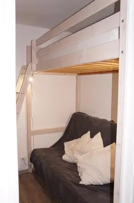 a bedroom with a bunk bed with white pillows at Verseau Flaine Forêt in Arâches-la-Frasse
