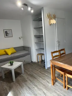 a living room with a couch and a table at Verseau Flaine Forêt in Arâches-la-Frasse