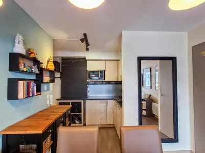 a kitchen with a table and chairs in a room at Spacieux appartement avec parking et accès piscine à Flaine - FR-1-425-231 in Arâches-la-Frasse