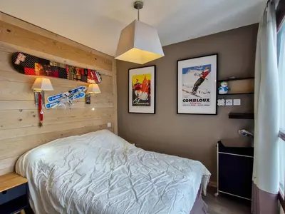 a bedroom with a bed and pictures on the wall at Spacieux appartement avec parking et accès piscine à Flaine - FR-1-425-231 in Arâches-la-Frasse