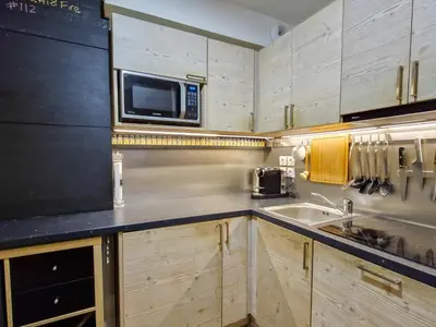 a kitchen with a microwave and a sink at Spacieux appartement avec parking et accès piscine à Flaine - FR-1-425-231 in Arâches-la-Frasse