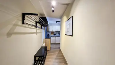 a hallway leading to a kitchen in a house at Résidence Le Panoramic - Appartement spacieux · Départ et retour skis aux pieds · Piscine · Parking inclus · Spa MAE-6931 in Magland