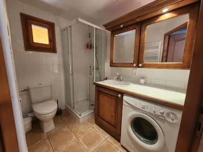 a bathroom with a toilet sink and a washing machine at Appartement 4 pièces avec Wifi et parking à Samoëns - FR-1-629-146 in Samoëns