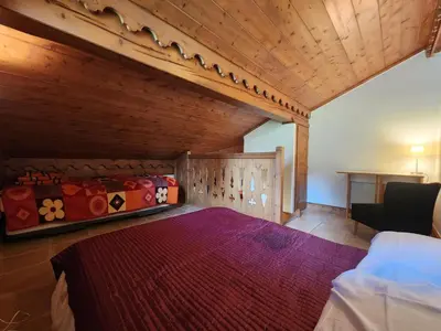 a bedroom with a bed and a wooden ceiling at Appartement 4 pièces avec Wifi et parking à Samoëns - FR-1-629-146 in Samoëns