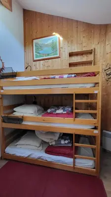 a bunk bed with several bunk beds in a room at Alpen Marvel in Morillon