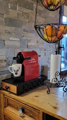 a red toaster sitting on top of a wooden table at Alpen Marvel in Morillon