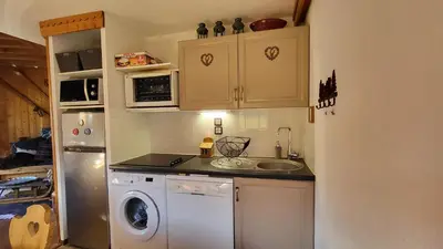 a kitchen with a sink and a washing machine at Alpen Marvel in Morillon