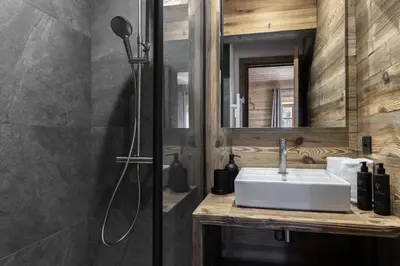 a bathroom with a white sink and a shower at Ferme des Tétras - Chalet de prestige en montagne in Saint-Gervais-les-Bains