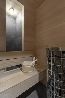 a sauna with a bucket on a wooden shelf at Ferme des Tétras - Chalet de prestige en montagne in Saint-Gervais-les-Bains