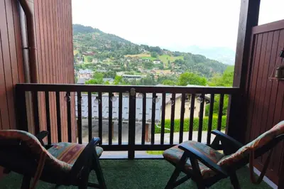 a balcony with chairs and a view of a mountain at Apartment near city center in Saint-Gervais-les-Bains