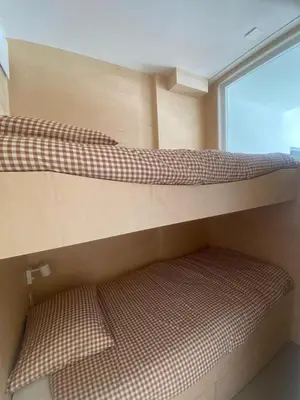 two bunk beds in a room with a window at Appartement Chamonix in Chamonix-Mont-Blanc