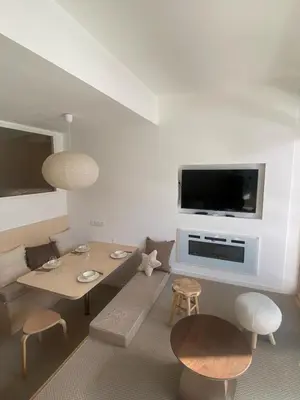 a living room with a table and a tv at Appartement Chamonix in Chamonix-Mont-Blanc