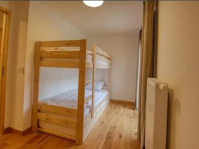 a bedroom with two bunk beds in a room at Bel appartement neuf 8 pers, Samoëns, près village, WIFI inclus - FR-1-642-100 in Samoëns