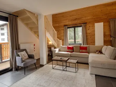 a living room with a couch and a table at Bel appartement neuf 8 pers, Samoëns, près village, WIFI inclus - FR-1-642-100 in Samoëns