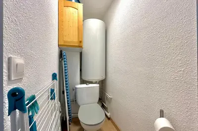 a small bathroom with a toilet in a room at Au Pied des Neiges in Demi-Quartier