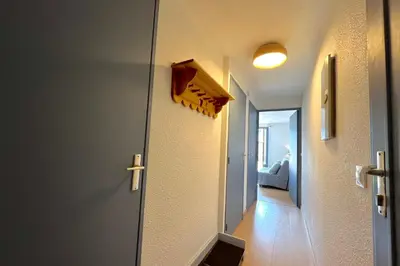 a hallway with a door leading to a room at Au Pied des Neiges in Demi-Quartier