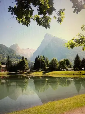 a view of a lake with a mountain in the background at Le Samoëns cosy 3 etoiles en centre ville in Samoëns