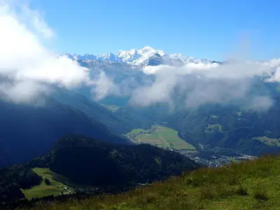 a view of a mountain with clouds in the foreground at Le Samoëns cosy 3 etoiles en centre ville in Samoëns