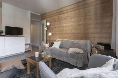 a living room with a couch and two chairs at Le Castel des Roches - Sejour ski & spa in Saint-Gervais-les-Bains