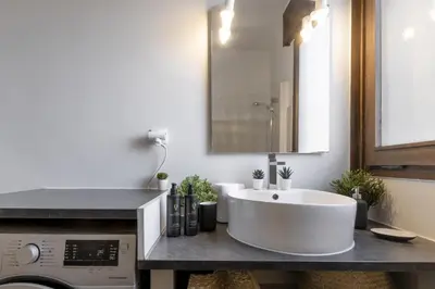a bathroom with a white tub and a sink at Le Castel des Roches - Sejour ski & spa in Saint-Gervais-les-Bains