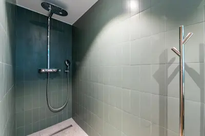 a shower in a bathroom with green tile at Chalet Croc Blanc, Chamonix - vu massif exceptionnel in Les Houches
