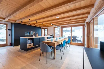 a dining room with a wooden table and chairs at Chalet Croc Blanc, Chamonix - vu massif exceptionnel in Les Houches