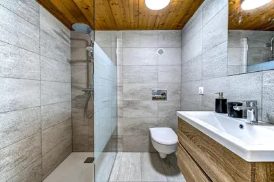 a bathroom with a toilet and a sink and a shower at Chamonix Centre - Sophisticated 2-Bedroom Duplex in Chamonix-Mont-Blanc