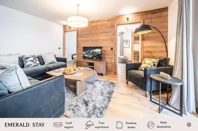 a living room with a couch and a table at Apartment Aubretia, Les Houches - by EMERALD STAY in Les Houches