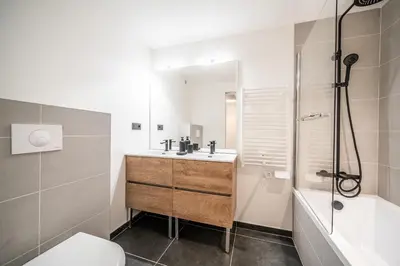 a bedroom with a bed with a wooden wall at Apartment Aubretia, Les Houches - by EMERALD STAY in Les Houches