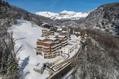 a kitchen and living room with a couch and a table at Apartment Aubretia, Les Houches - by EMERALD STAY in Les Houches