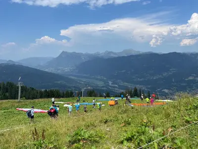 a group of people on a hill flying kites at Appartement 4 personnes Samoëns 1600 in Samoëns