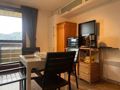 a living room with a table and a television at Appartement 4 personnes Samoëns 1600 in Samoëns