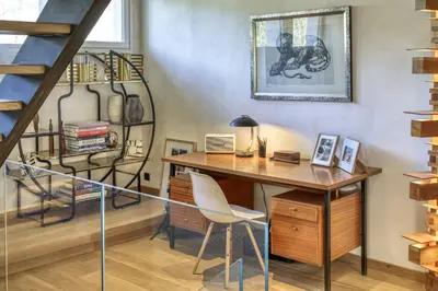 a home office with a desk and a staircase at Chalet Boucle in Megève