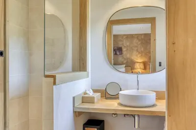 a bathroom with a sink and a mirror at Chalet Boucle in Megève