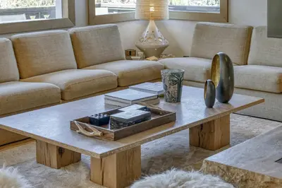 a living room with a couch and a coffee table at Chalet Boucle in Megève