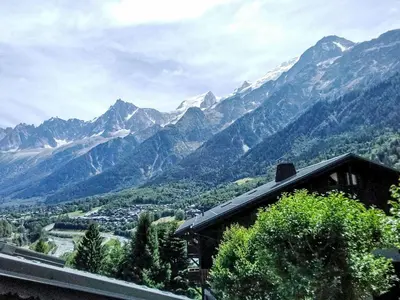 a view of a mountain range with a house at Apartment Les Grands Balcons by Interhome in Les Houches