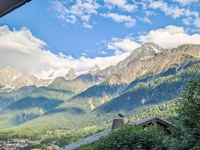 a view of a mountain range with a city at Apartment Les Grands Balcons by Interhome in Les Houches