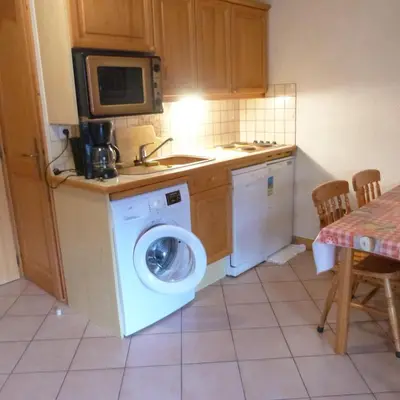 a kitchen with a washing machine and a sink at LES JARDINS ALPINS CHEZ Olivier in Saint-Gervais-les-Bains