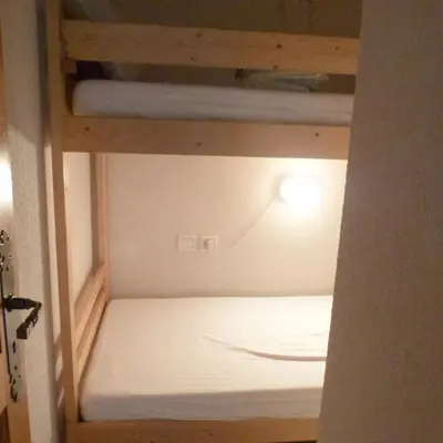 ajar view of a bunk bed in a room at LES JARDINS ALPINS CHEZ Olivier in Saint-Gervais-les-Bains