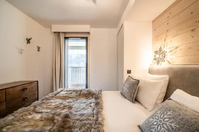 a bedroom with a bed and a window at Apartment Camox, Les Houches - by EMERALD STAY in Les Houches
