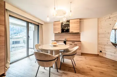 a kitchen and dining room with a table and chairs at Apartment Camox, Les Houches - by EMERALD STAY in Les Houches