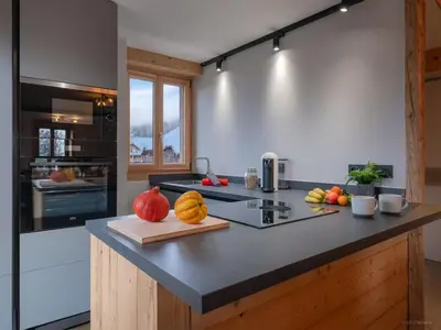 a kitchen with a counter with fruits on it at TigerLily, Samoens in Samoëns