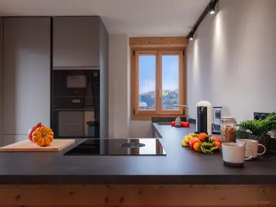 a kitchen with a counter with fruits and vegetables on it at TigerLily, Samoens in Samoëns
