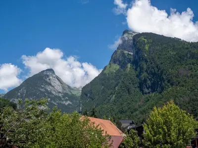 a view of a mountain with trees and buildings at TigerLily, Samoens in Samoëns
