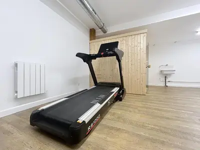 a gym with a black treadmill in a room at Appartement neuf 2 chambres près des pistes à Combloux avec parking - FR-1-560-158 in Combloux