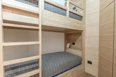 a bedroom with two bunk beds in a room at Elegant 3 Bedroom Apartment, Central Chamonix in Chamonix-Mont-Blanc