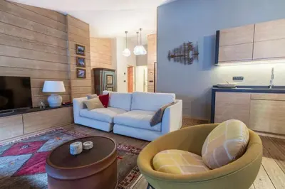 a living room with a couch and a table at Elegant 3 Bedroom Apartment, Central Chamonix in Chamonix-Mont-Blanc