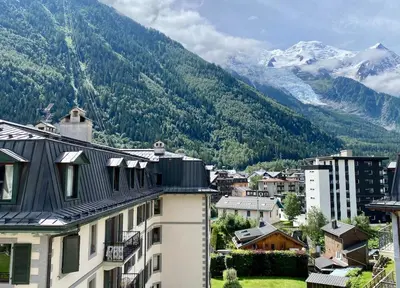a view of a city with mountains in the background at Elegant 3 Bedroom Apartment, Central Chamonix in Chamonix-Mont-Blanc